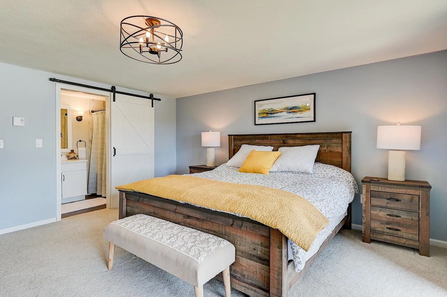 Downstairs “bedroom” with plush king bed in an open area.
